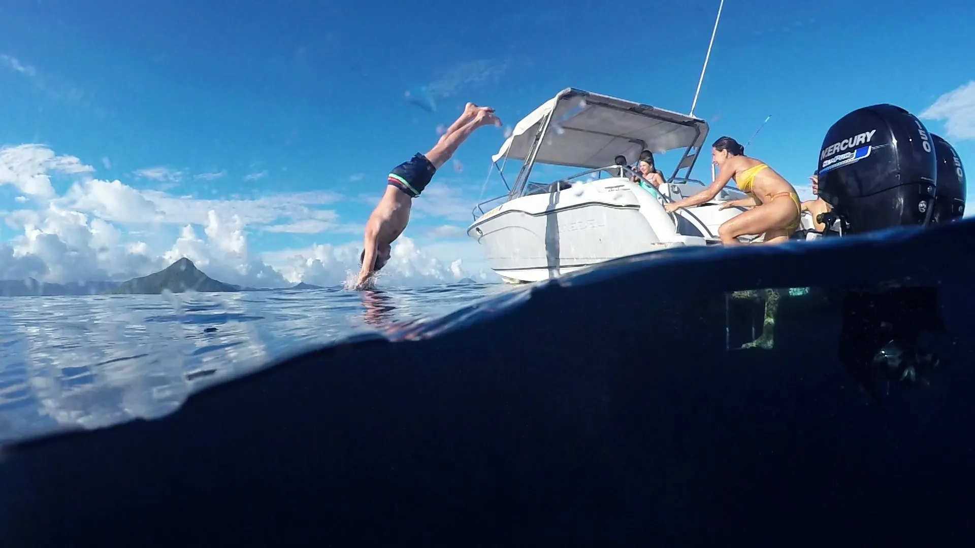 Swimmer diving off a speedboat into the clear sea off Mauritius