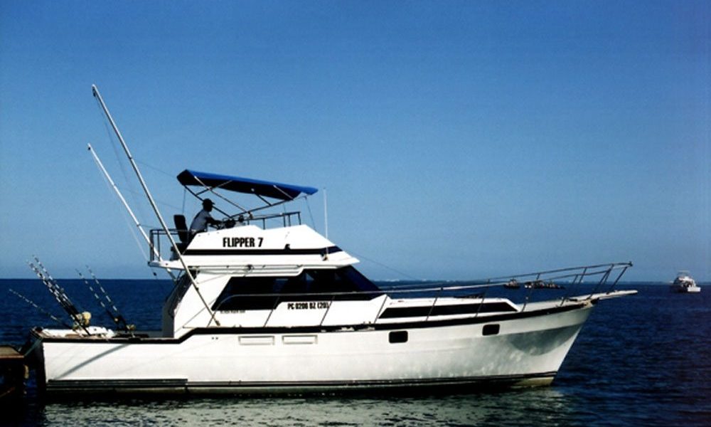 Sport fishing boat Flipper 7 moored on calm water